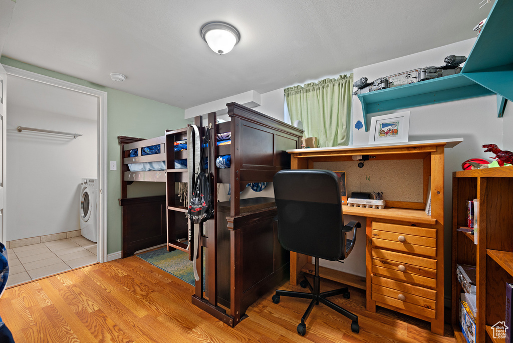 Tiled office space featuring washer / dryer