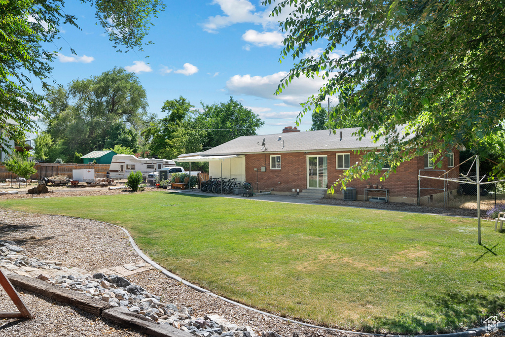 View of yard with entry steps and a patio area