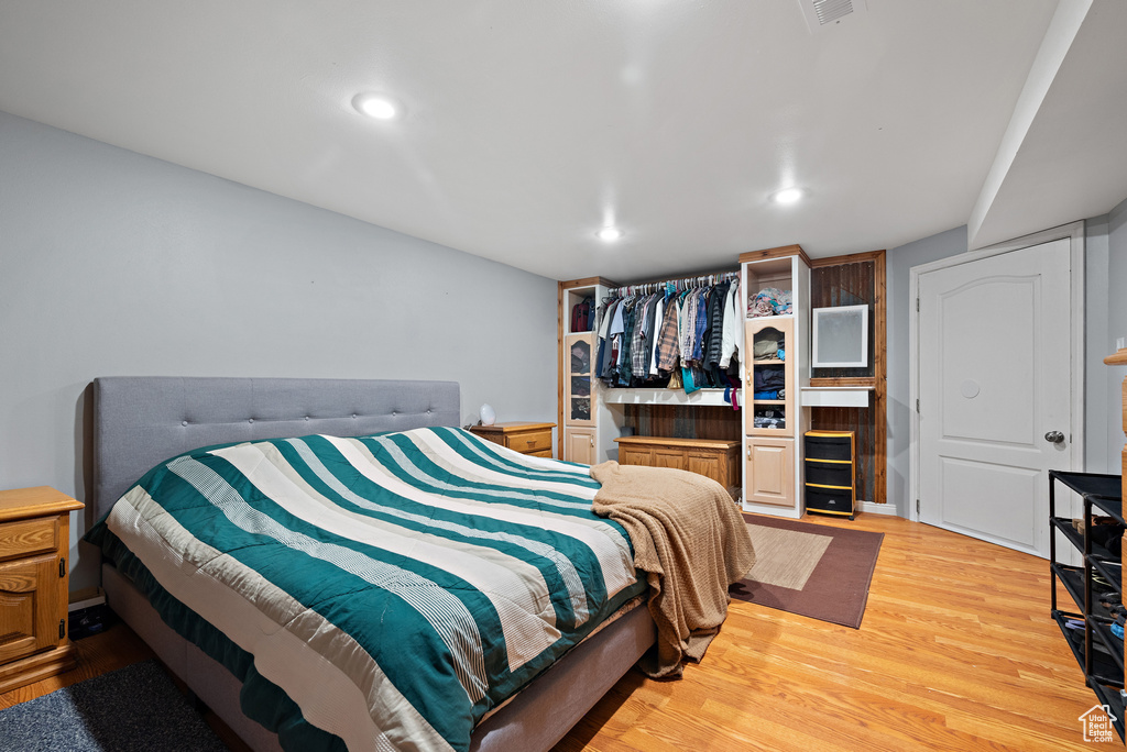 Bedroom with light wood-style flooring and recessed lighting