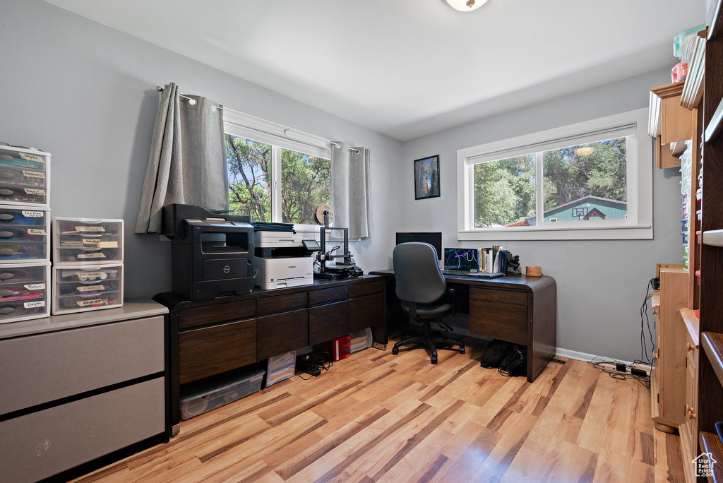 Office area with light wood-style flooring