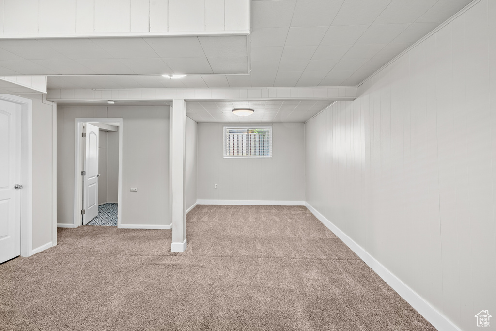 Basement featuring carpet floors and baseboards