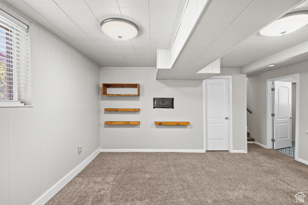 Basement with carpet and stairway