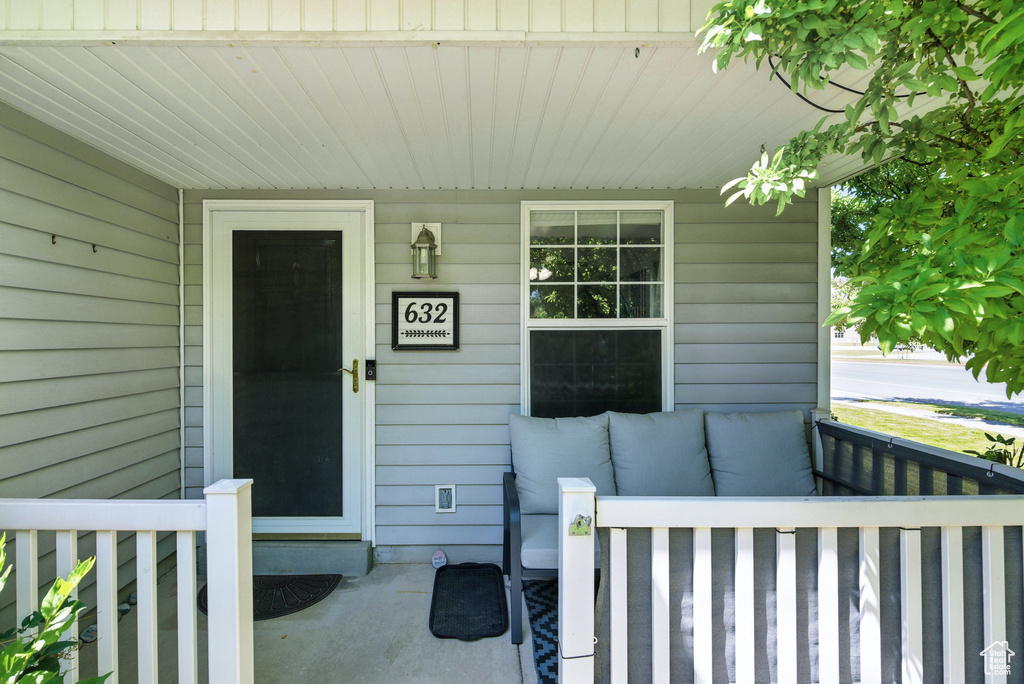 Doorway to property featuring a porch
