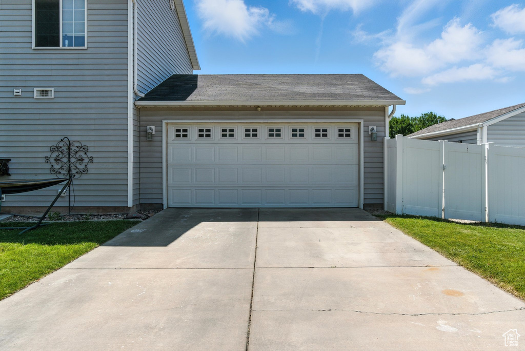 Garage featuring concrete driveway