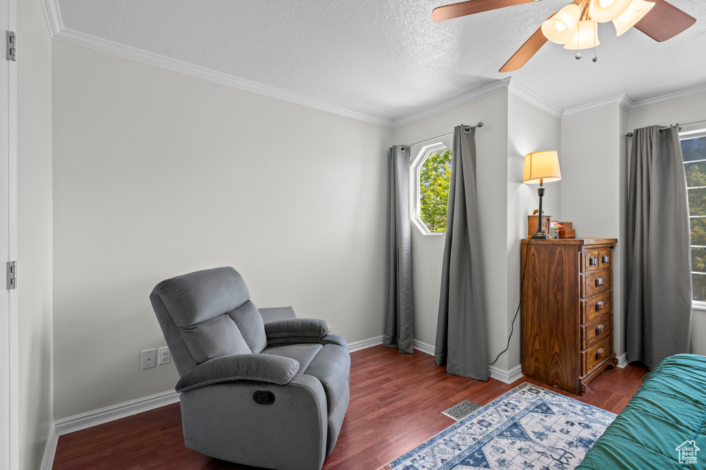 Sitting room featuring ceiling fan, wood finished floors, crown molding, and a textured ceiling