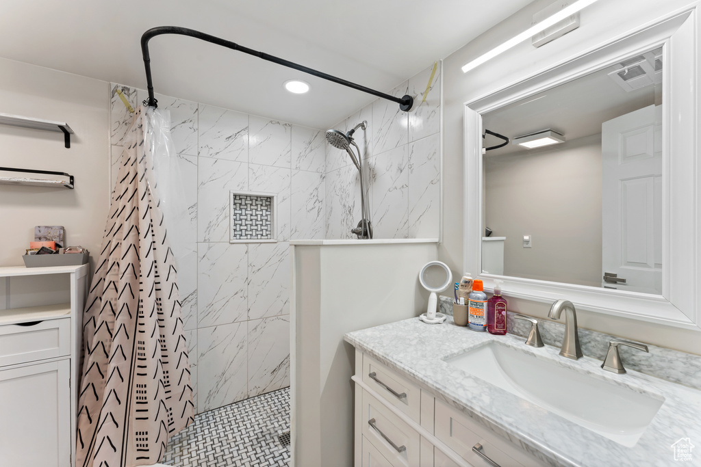 Bathroom featuring vanity, a shower stall, and recessed lighting