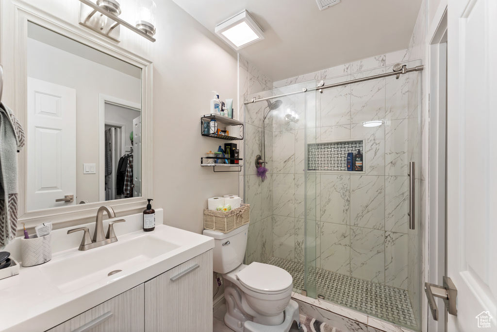 Full bathroom with a marble finish shower and vanity