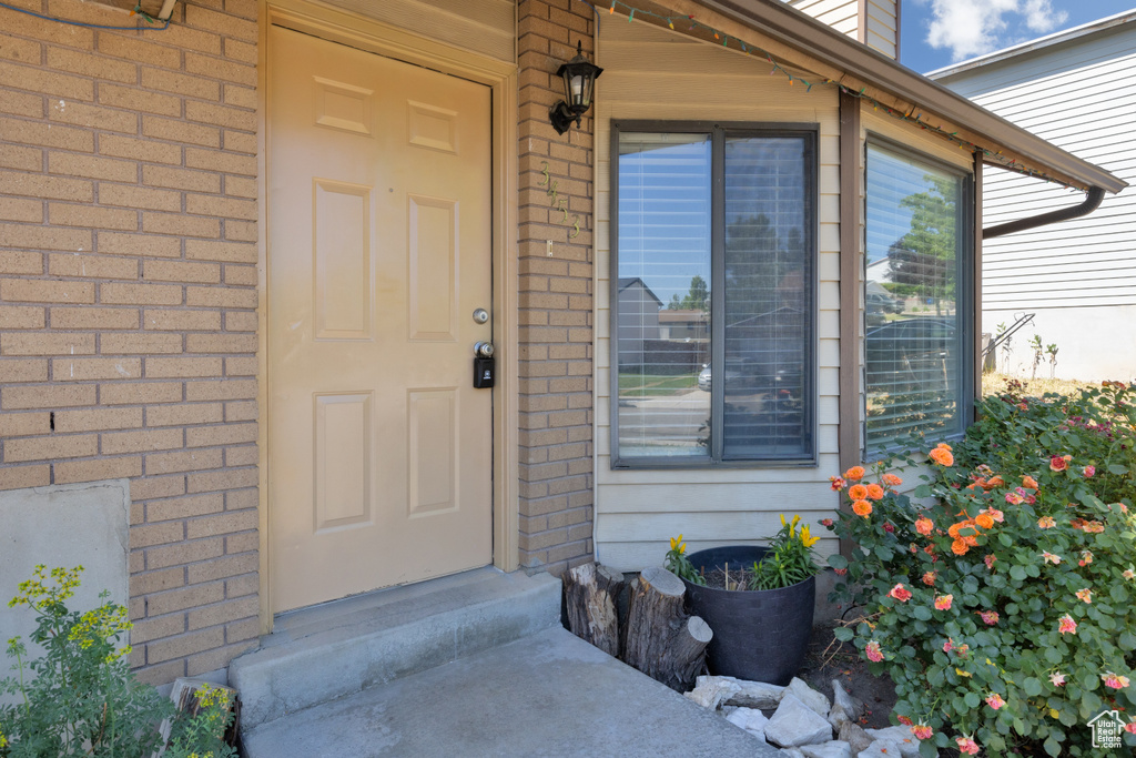 Doorway to property with brick siding