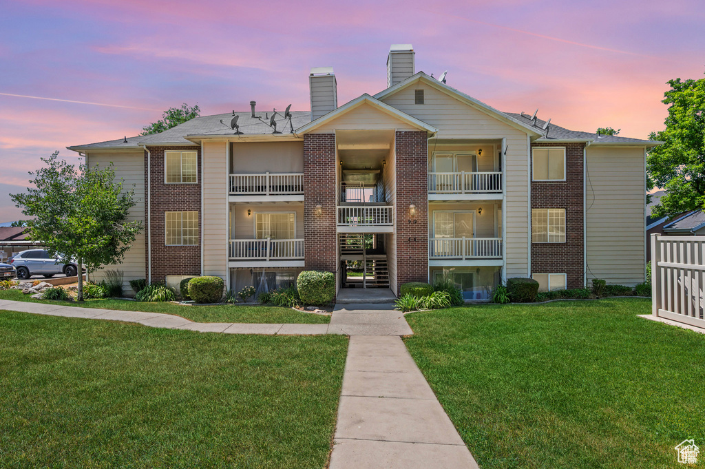 View of property at dusk