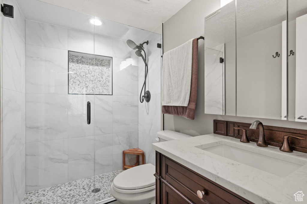 Bathroom featuring a shower stall and vanity