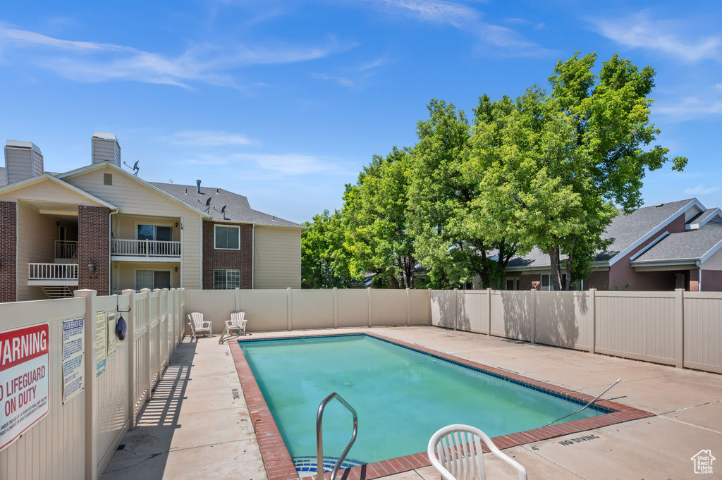 Community pool with a patio
