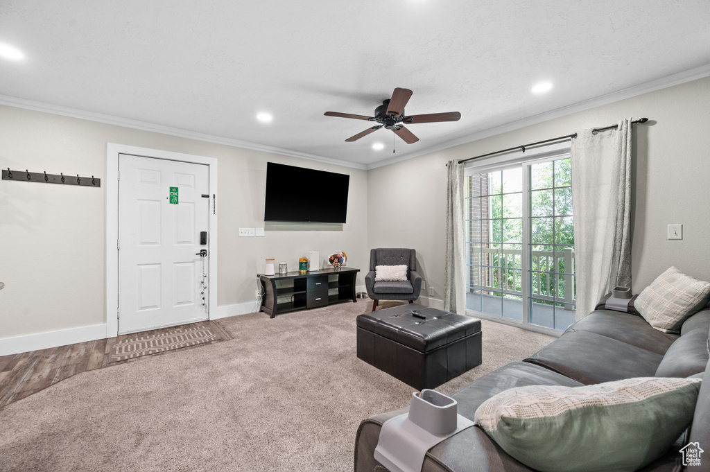 Living room featuring recessed lighting, ceiling fan, crown molding, and carpet floors