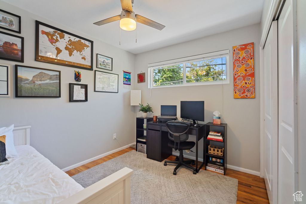 Office area with wood finished floors and a ceiling fan