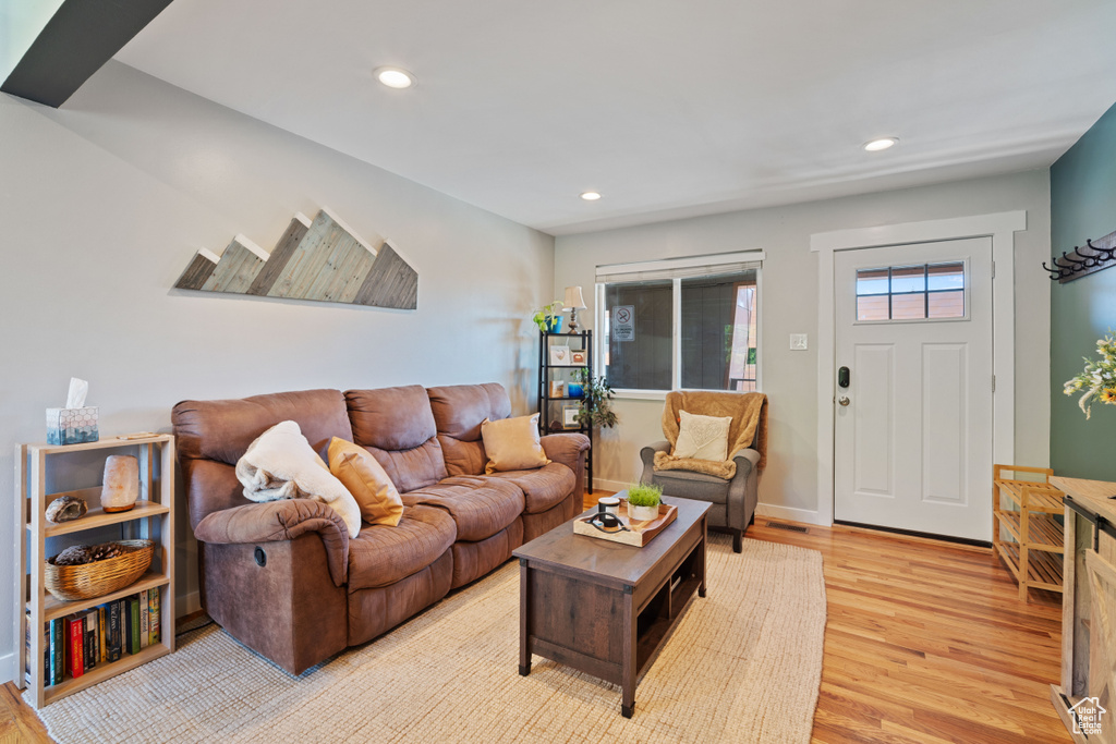 Living area featuring light wood-style flooring and recessed lighting