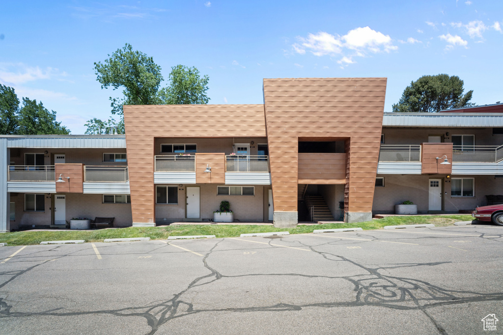 View of property with uncovered parking