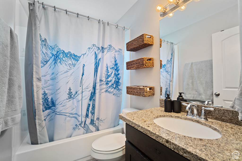 Full bath featuring vanity and shower / bath combination with curtain