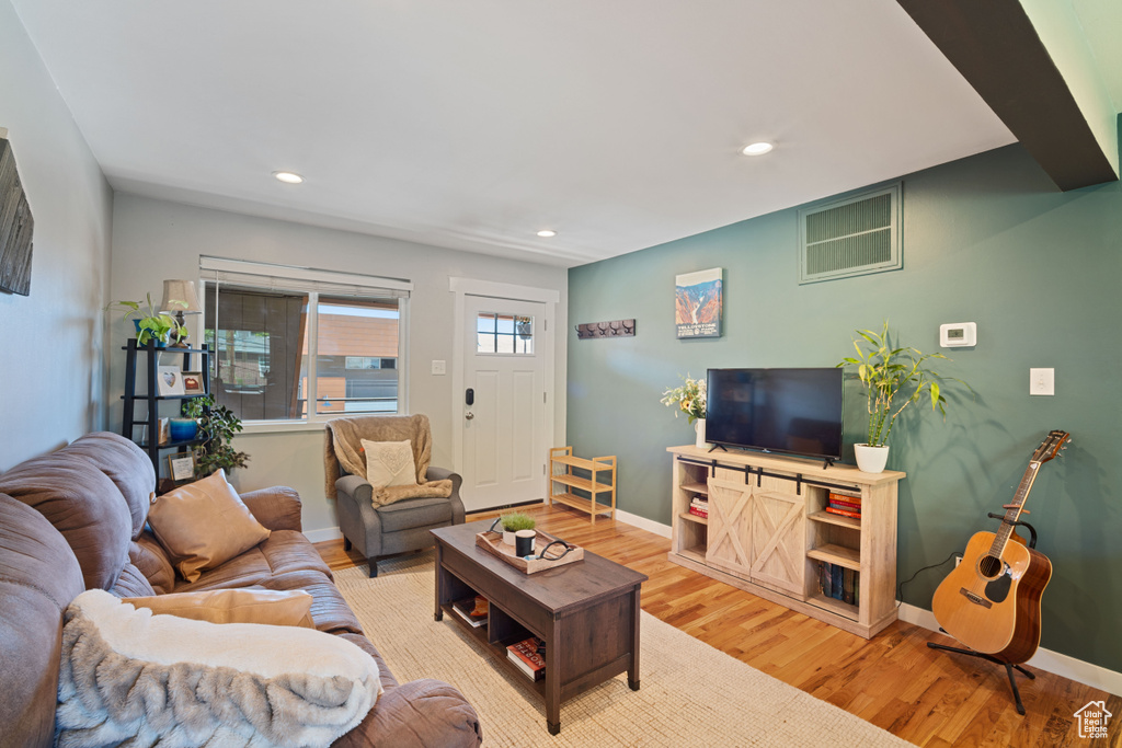 Living area with wood finished floors and recessed lighting