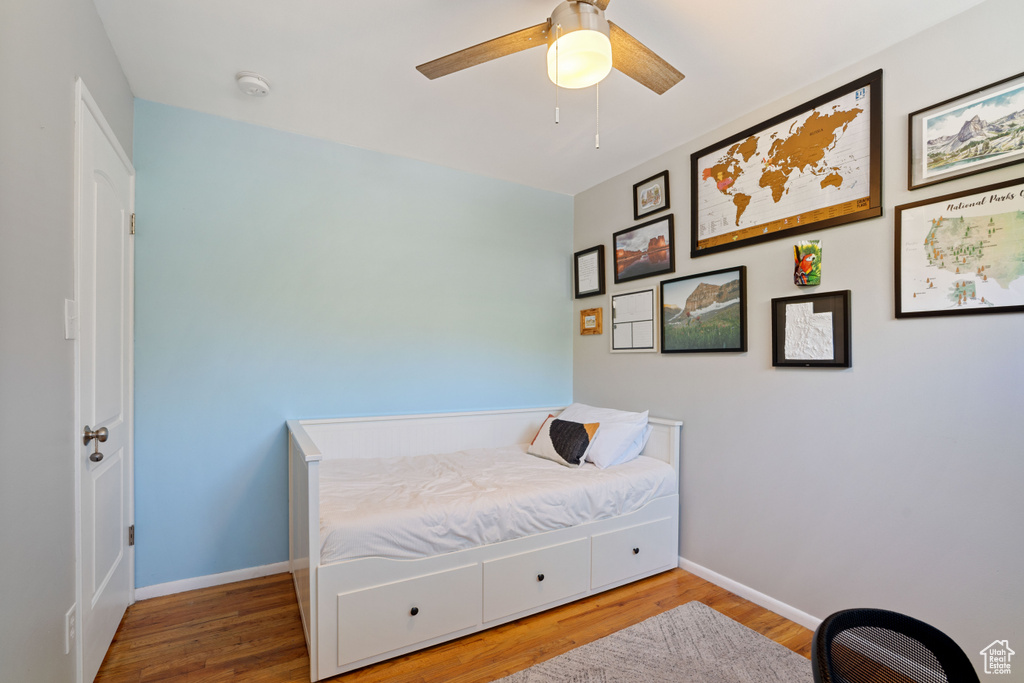 Bedroom featuring wood finished floors and a ceiling fan