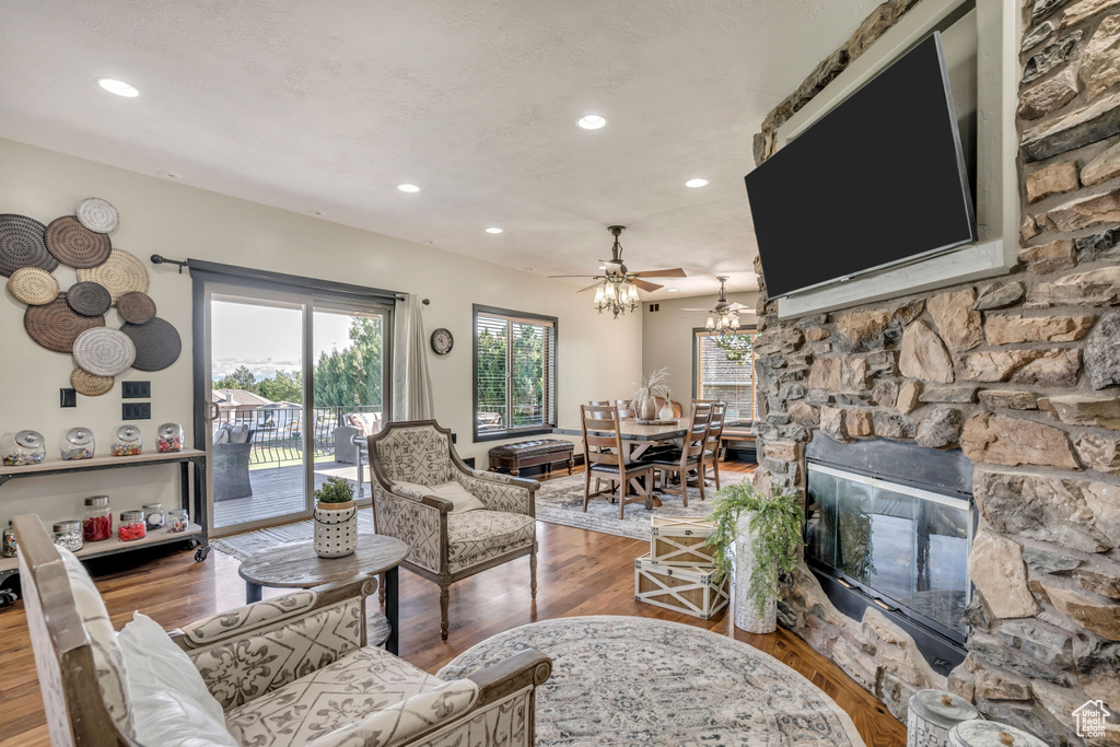 Living room with wood finished floors, recessed lighting, and a ceiling fan