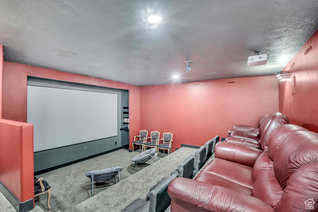 Carpeted cinema room with baseboards and recessed lighting