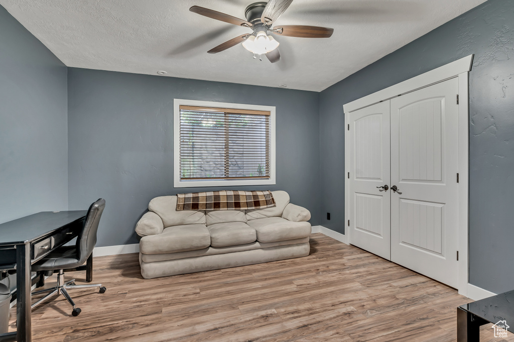 Office space with a ceiling fan and wood finished floors