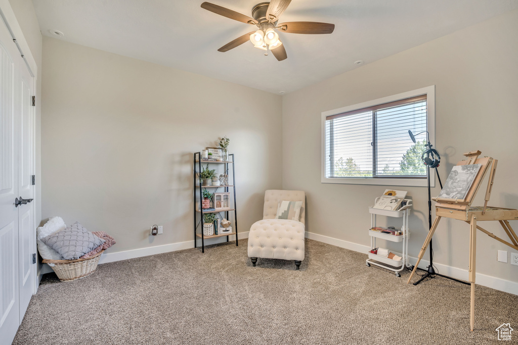 Sitting room featuring carpet floors and a ceiling fan