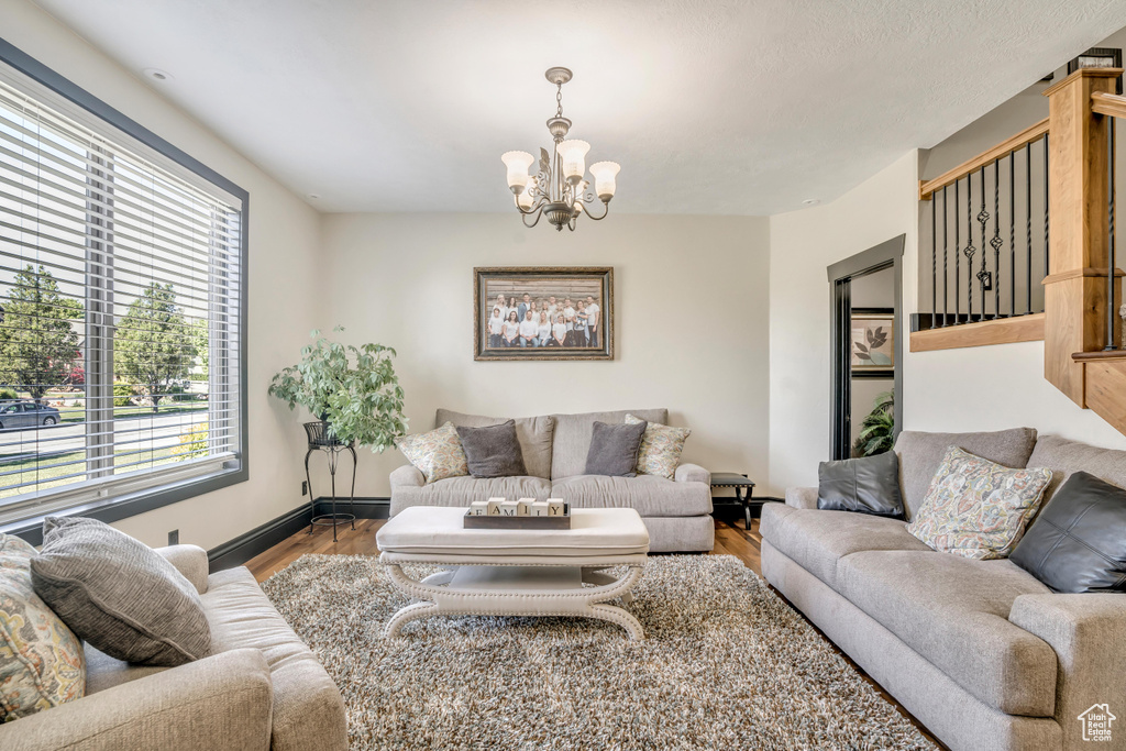 Living room featuring a chandelier and wood finished floors