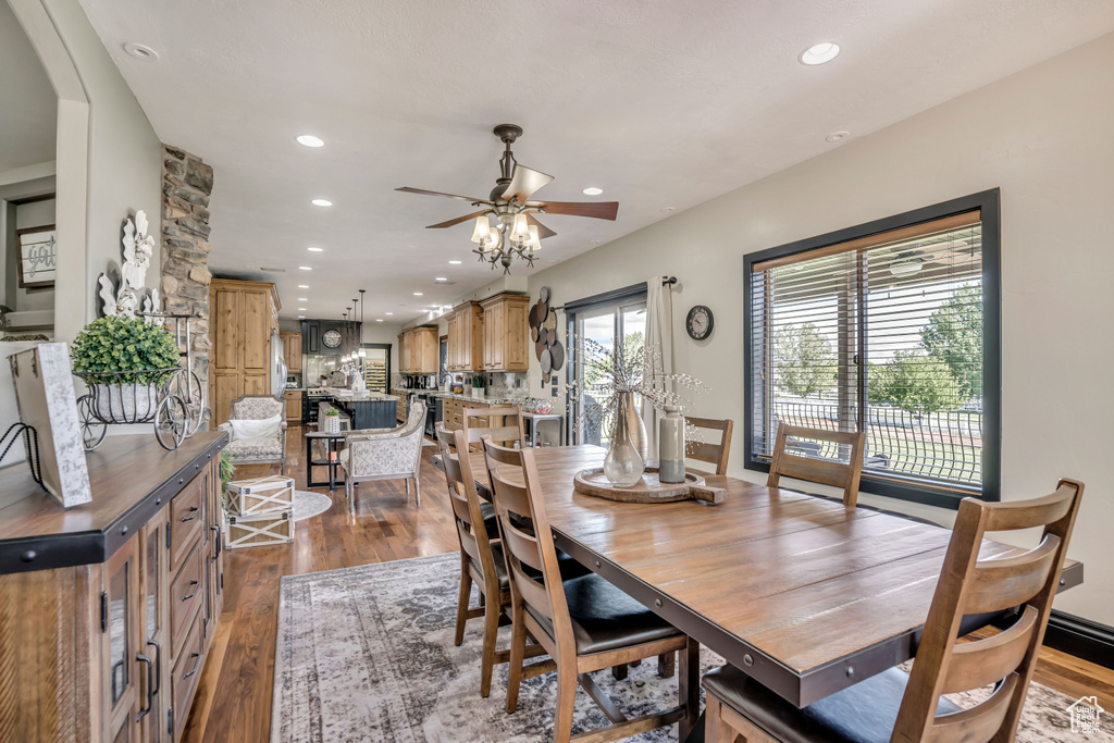 Dining space with dark wood-style floors, recessed lighting, and ceiling fan