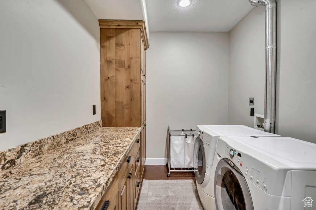 Laundry area with washer and clothes dryer, cabinet space, and recessed lighting