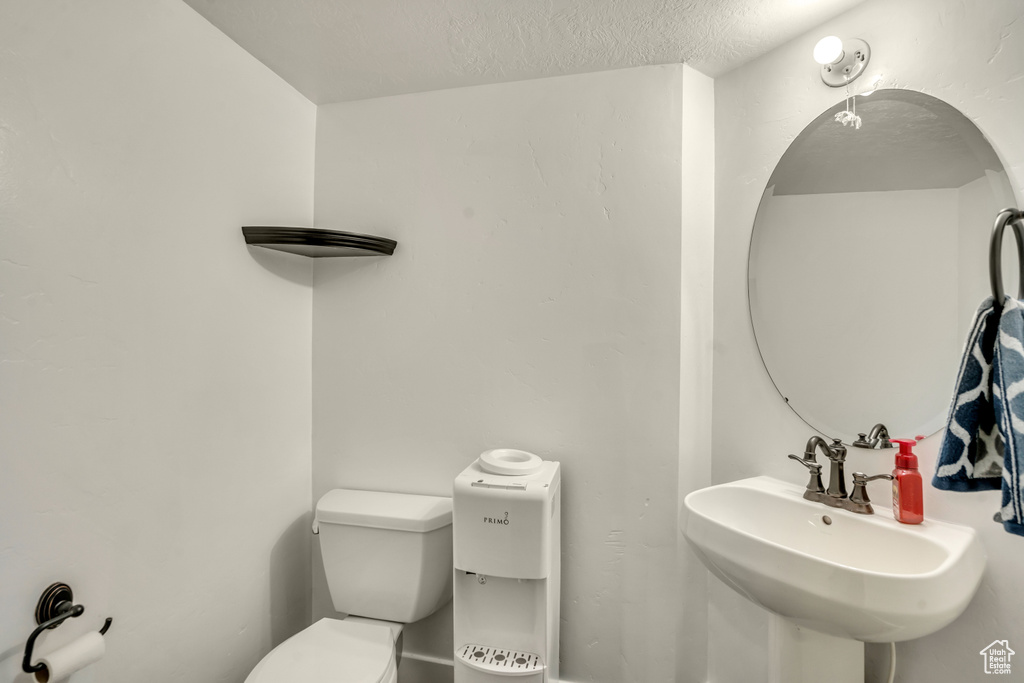 Bathroom featuring a sink and a textured ceiling