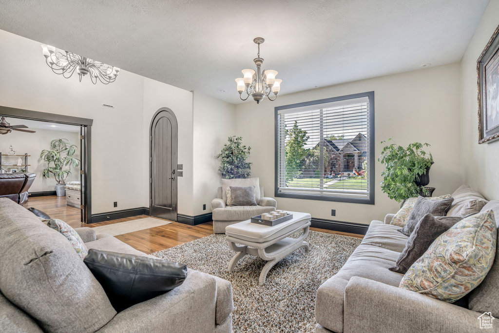 Living area with a chandelier and light wood-style flooring
