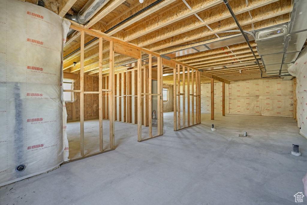 Miscellaneous room with heating unit and unfinished concrete floors