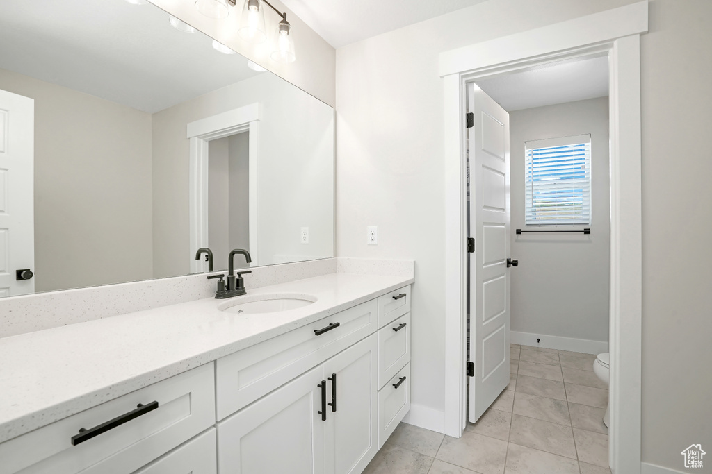Bathroom with vanity and tile patterned floors