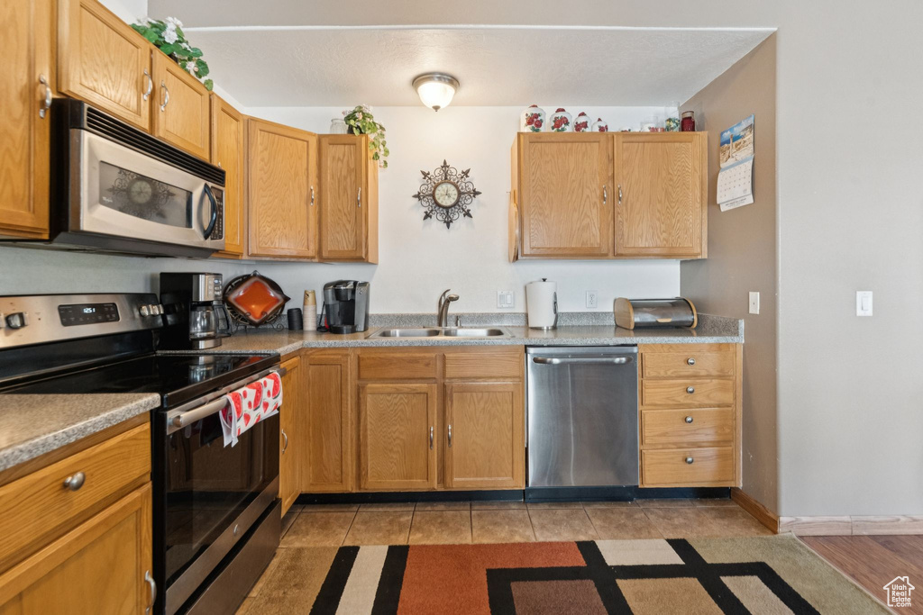 Kitchen featuring appliances with stainless steel finishes and light tile patterned floors