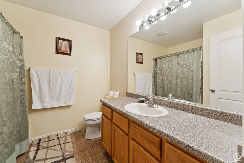Full bath with toilet and vanity