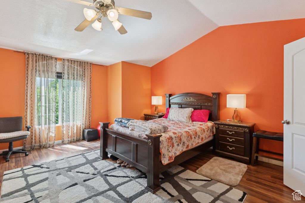 Bedroom featuring vaulted ceiling, wood finished floors, and ceiling fan