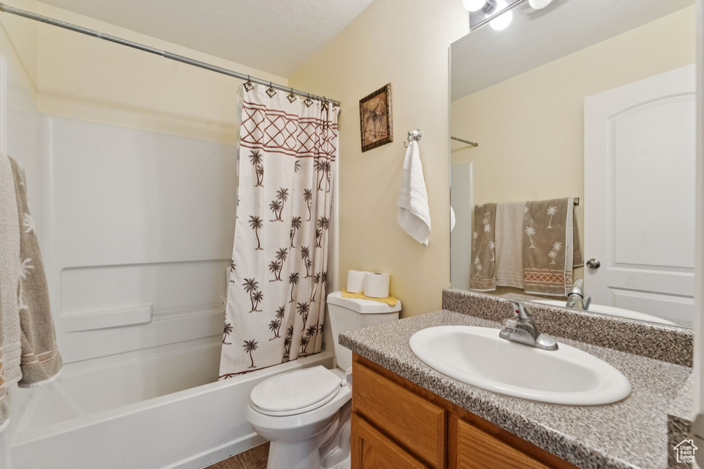 Bathroom with vanity and shower / bath combo with shower curtain