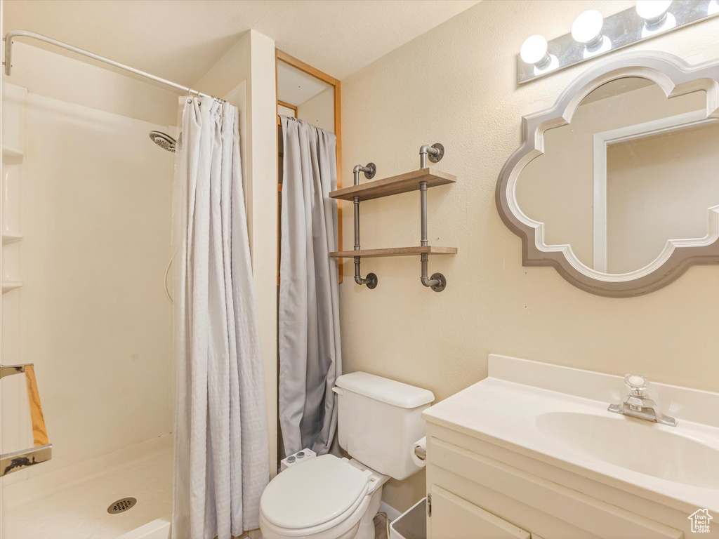 Full bath with vanity and a shower stall