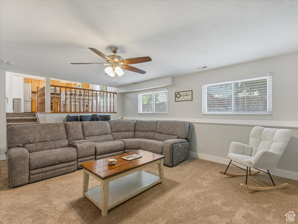 Living room with carpet floors and a ceiling fan