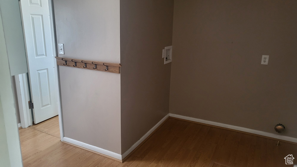 Corridor with light wood finished floors and baseboards