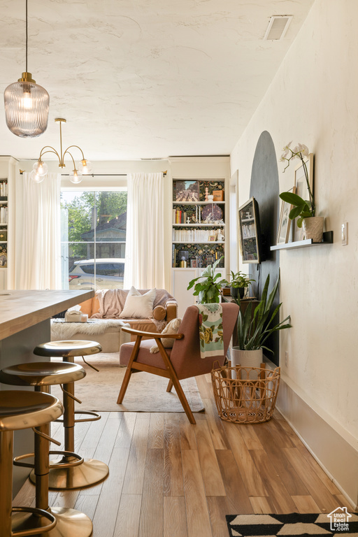 Living area featuring wood finished floors and built in shelves