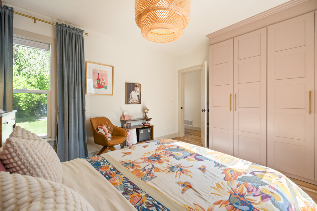 Bedroom with light wood-type flooring and a closet