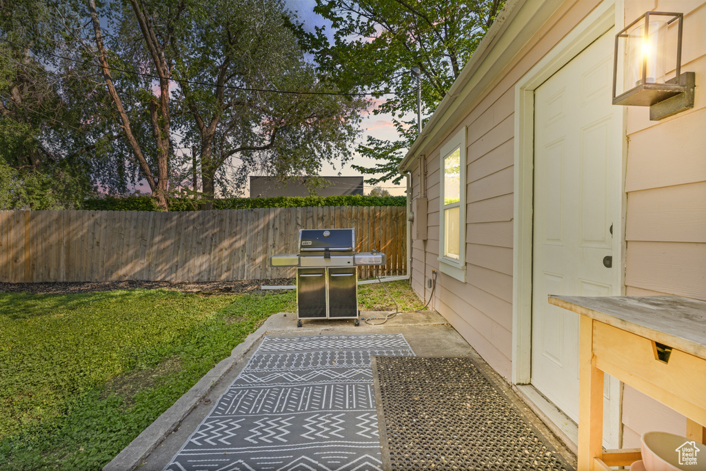 Yard at dusk featuring a patio area