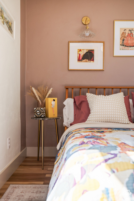 Bedroom featuring wood finished floors and baseboards