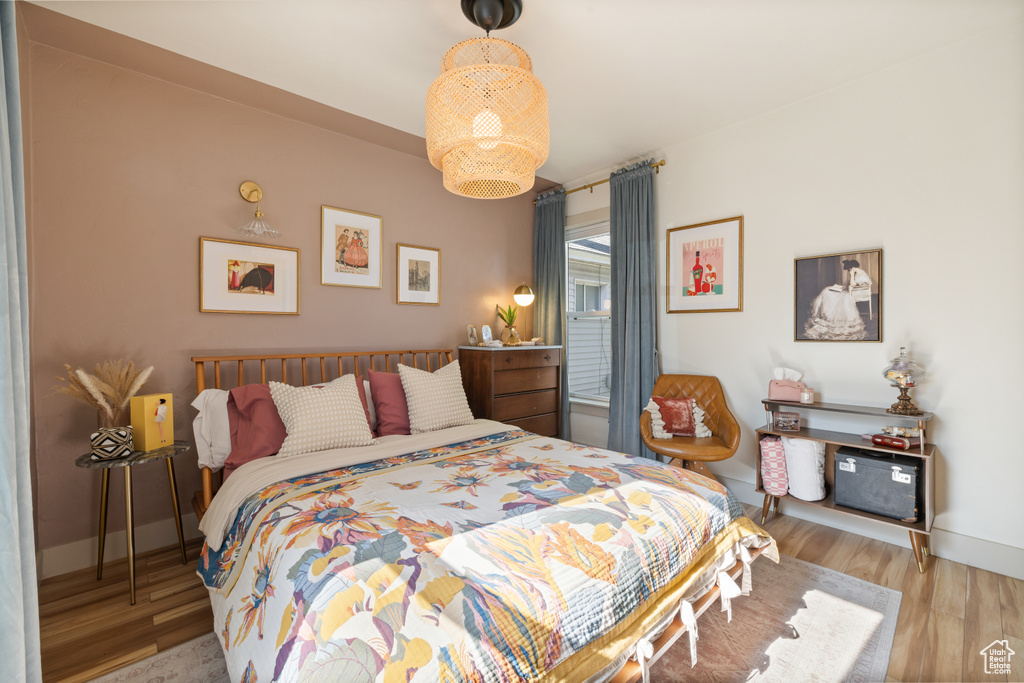 Bedroom with wood finished floors and baseboards