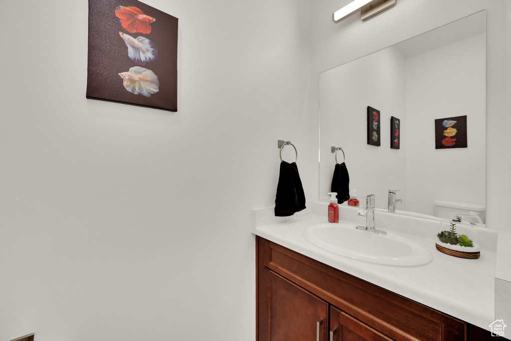 Bathroom featuring vanity and toilet