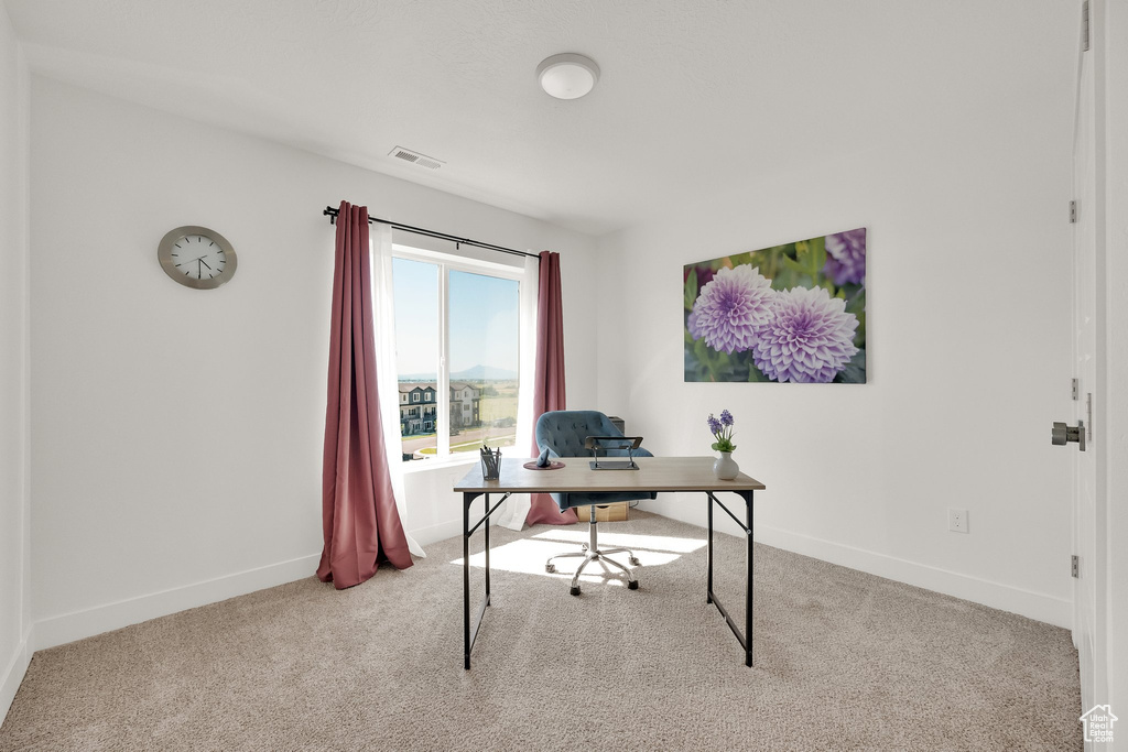 Carpeted office featuring baseboards
