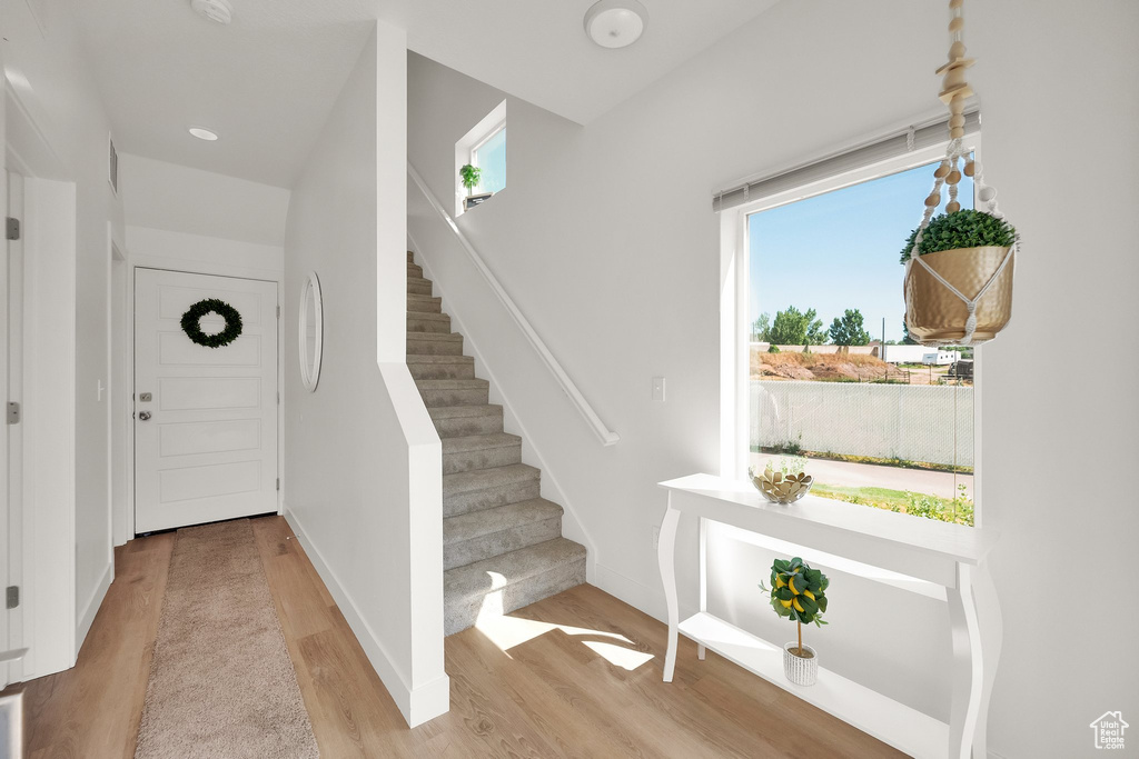 Foyer entrance featuring wood finished floors and stairway