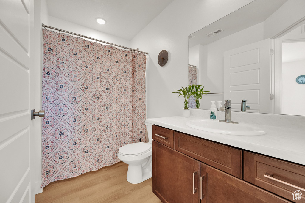 Full bath featuring vanity, wood finished floors, recessed lighting, and a shower with shower curtain