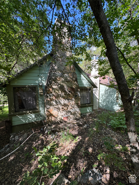 View of side of property with a chimney